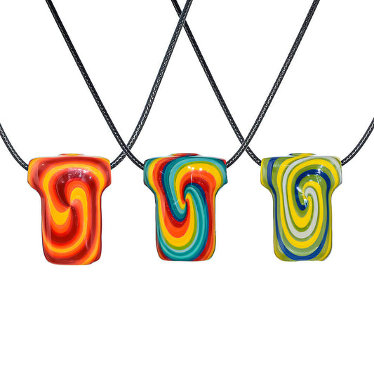 Three T-shirt shaped glass pendants featuring vibrant wigwag swirl patterns in orange, rainbow, and green hues on black cords.
