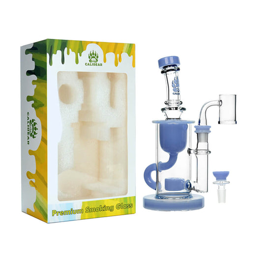 Calibear Colored Klein Recycler Dab Rig in periwinkle blue displayed next to its premium foam-lined Calibear gift box — featuring a clear borosilicate cylindrical chamber with blue Seed of Life percolator, internal vortex can, Klein recycler loop, straigh