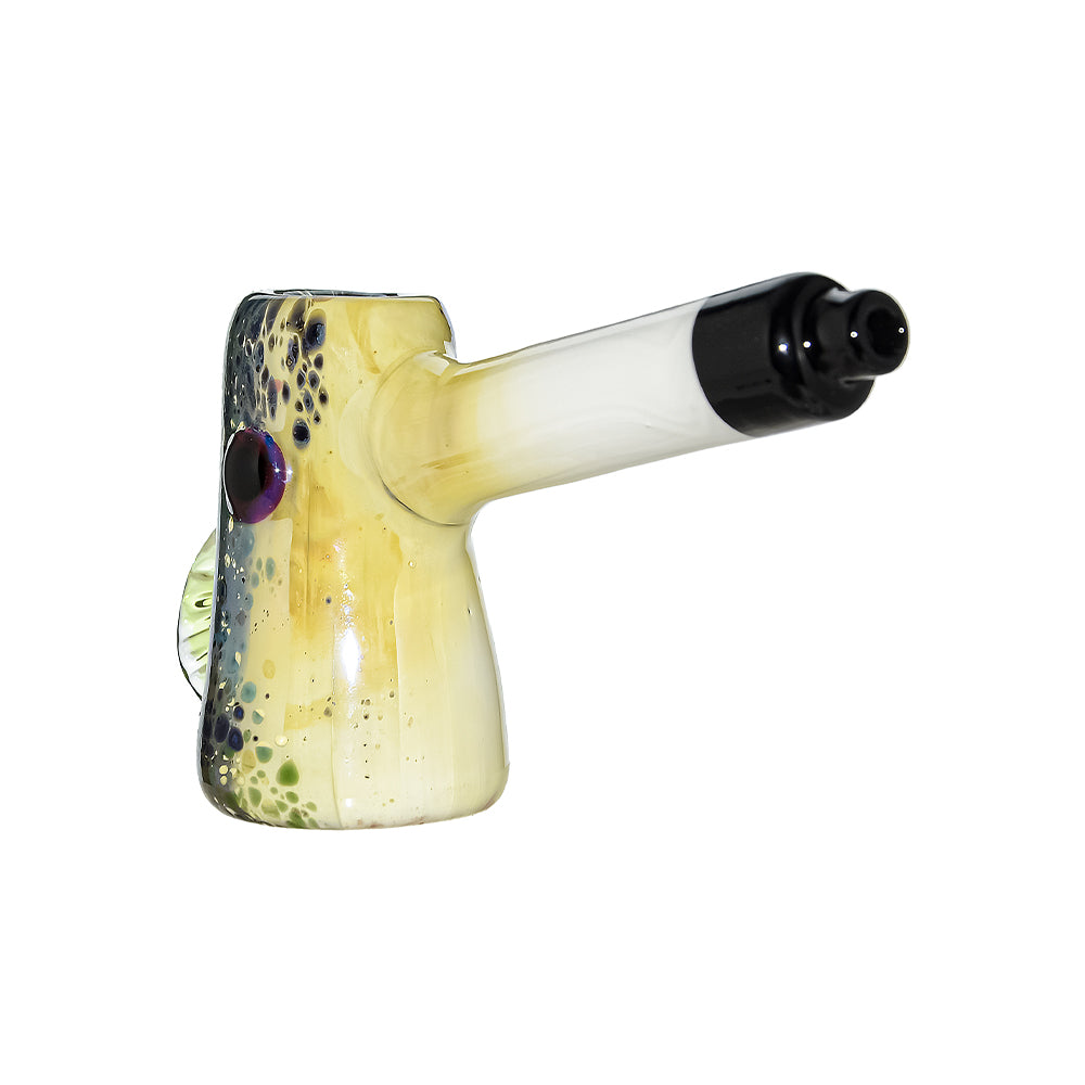 CaliBear Glass Puffer Fish hand pipe featuring a yellow-green speckled body, large eyes, and a white stem with black mouthpiece on a white background.