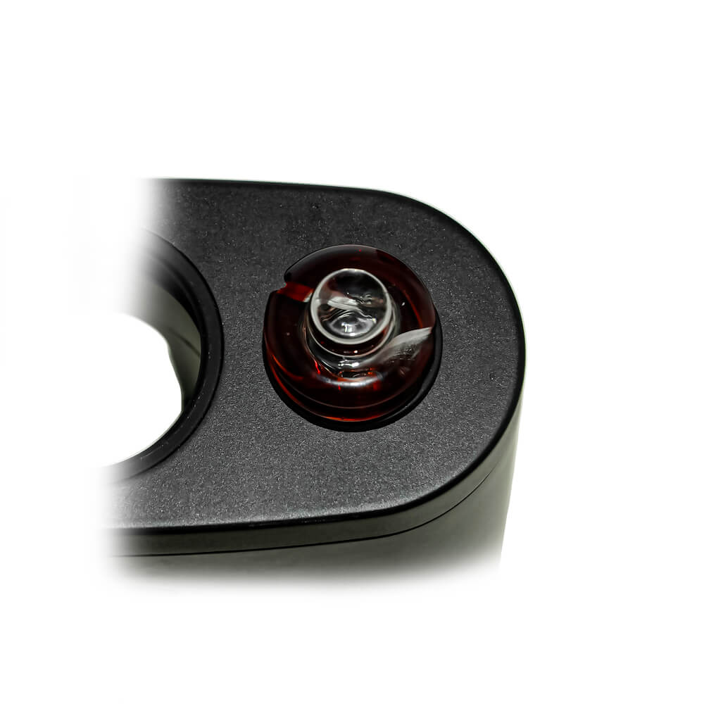 Calibear Premium Spinner Carb Cap (Self-Striking Red), top-down close-up showing the glass opening and spiral airflow channels while installed on a compatible device