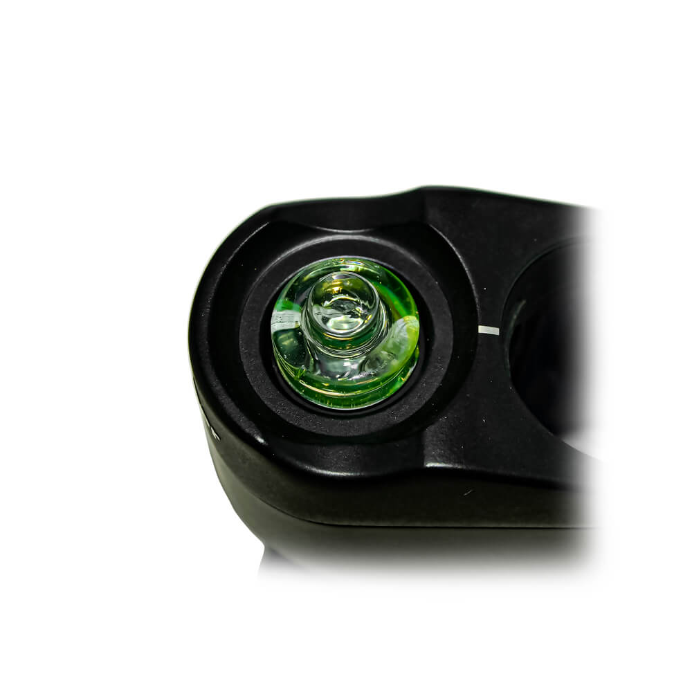 Calibear Spinner Carb Cap （lime candy) installed on a compatible atomizer, close-up top view showing the circular glass opening, spiral airflow design and decorative amber accents