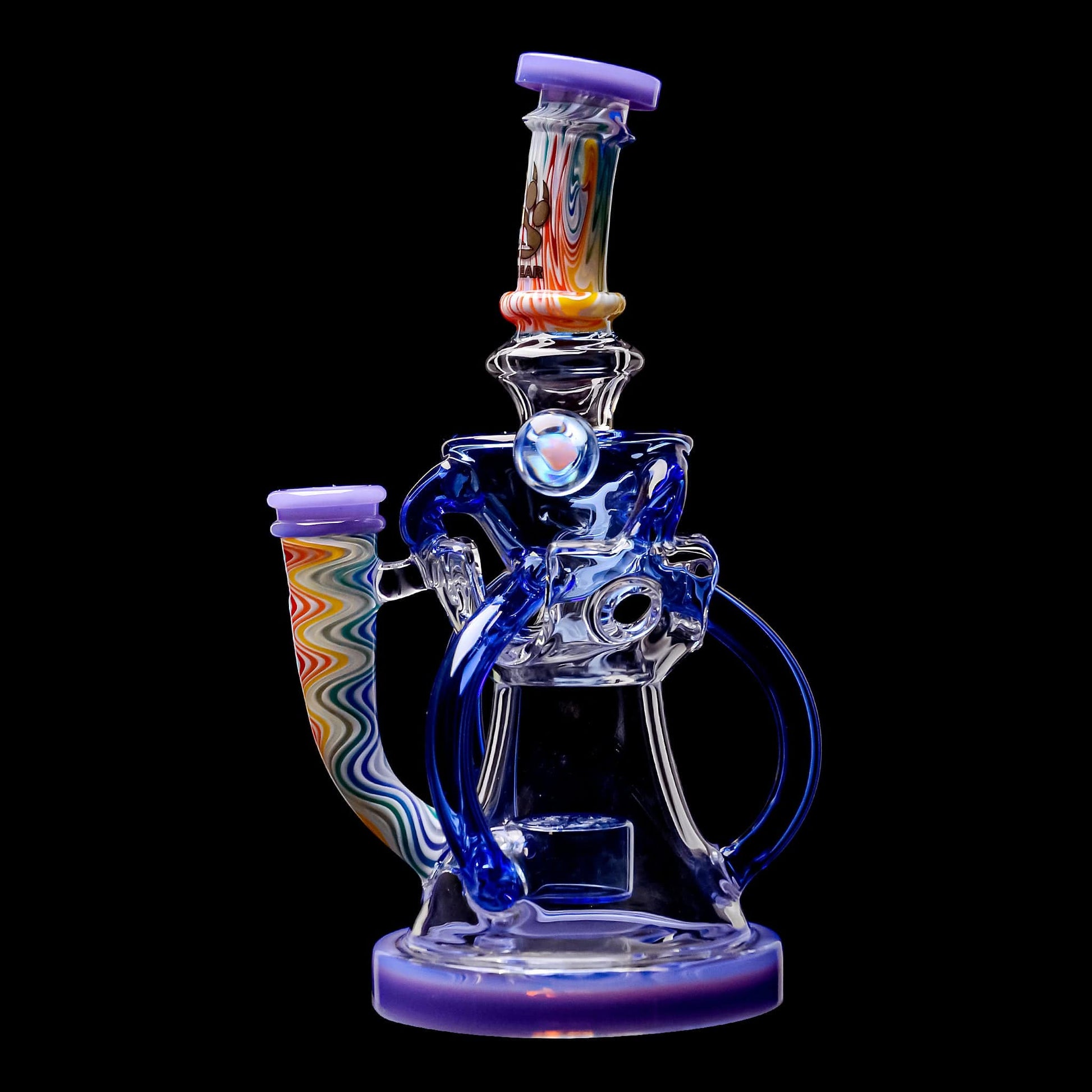 Five Calibear Heady Wigwag Fab Klein recycler dab rigs with intricate worked glass neck sections, encasements, colored accents in blue, orange, teal, purple, and green, featuring a Flower of Life percolator.