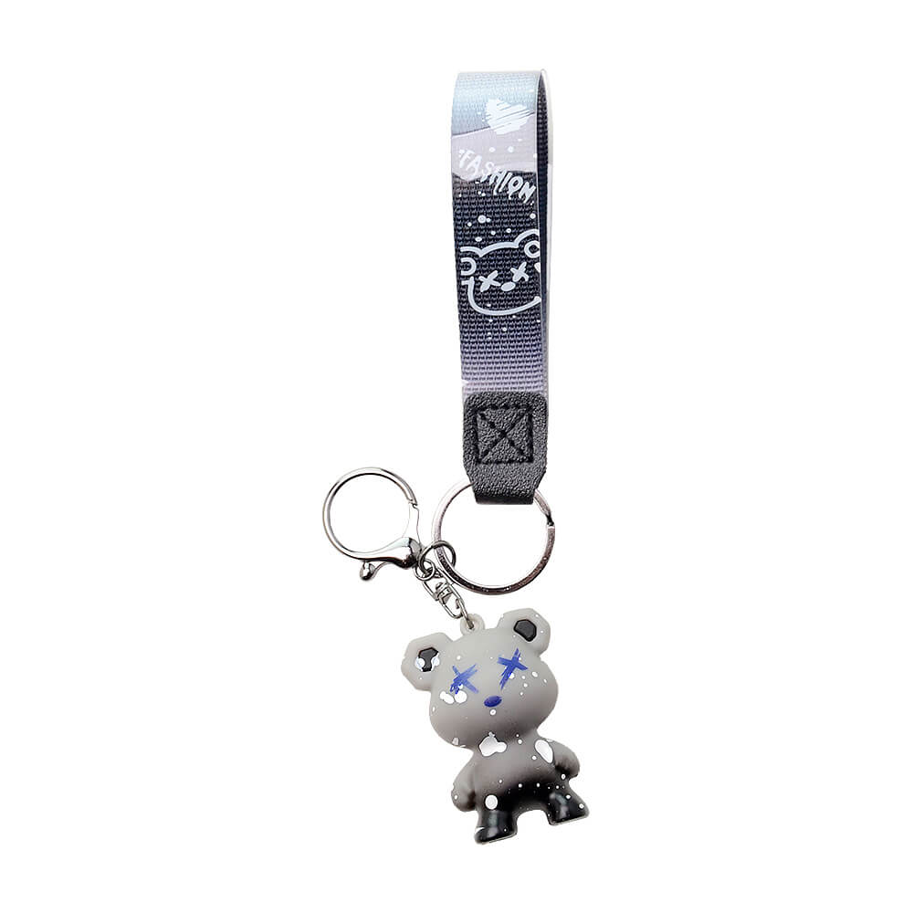 Five Calibear collectible streetwear bear keychain figurines in black, green, blue, purple, and red alongside a premium black and silver metal Calibear bear paw logo keychain.