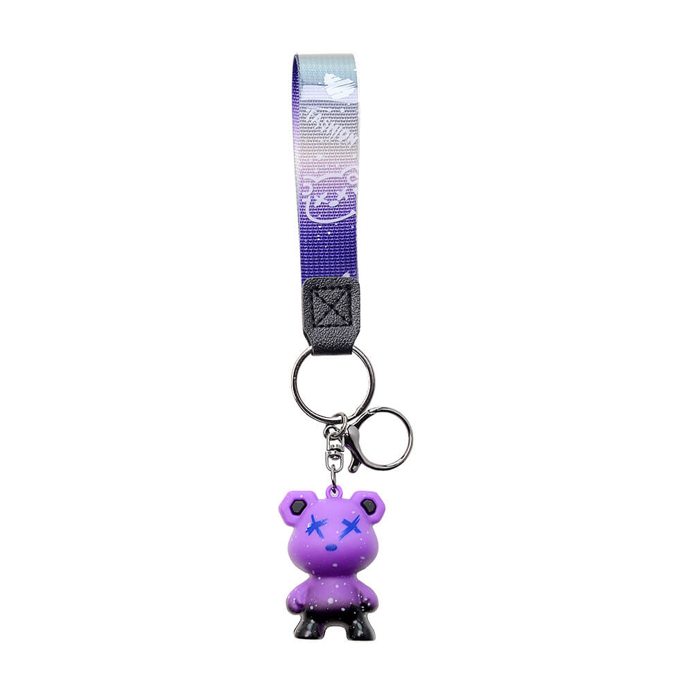 Five Calibear collectible streetwear bear keychain figurines in black, green, blue, purple, and red alongside a premium black and silver metal Calibear bear paw logo keychain.