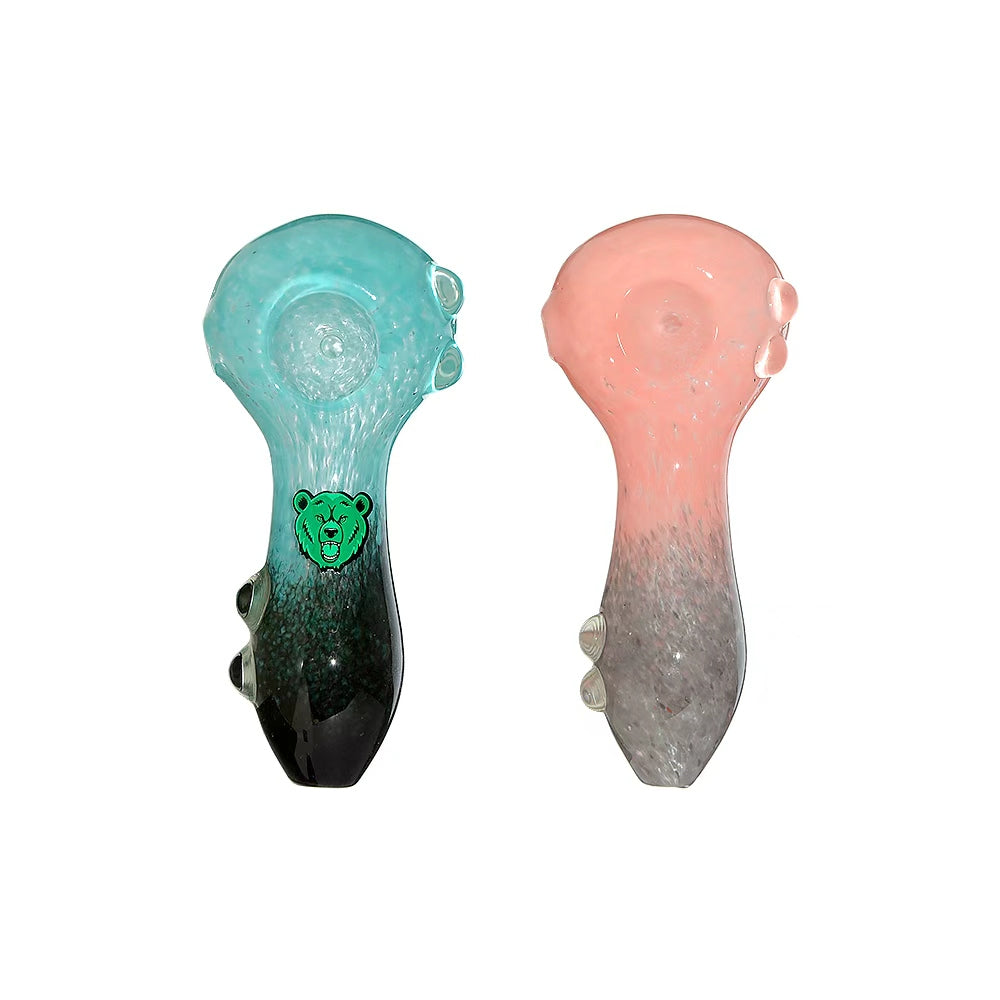 Two Calibear dual-tone glass spoon pipes in teal-black and pink-grey with marble feet stabilizers and green bear logo.