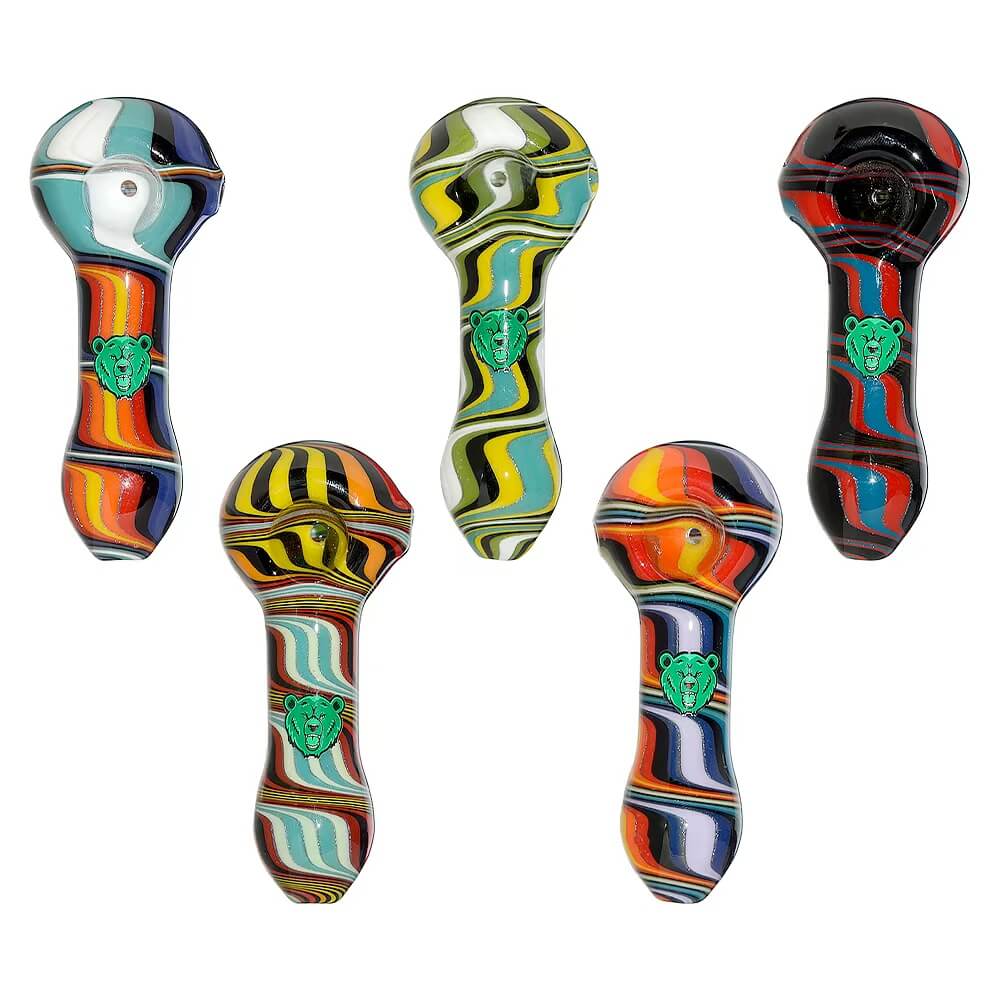 Five hand-blown glass spoon pipes featuring vibrant colorful wigwag patterns in yellow, orange, blue, and black, each marked with a green Calibear logo.