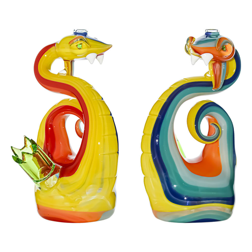 Heady wigwag snake dab rig featuring vibrant orange, yellow, and blue striped glass patterns with shimmering opal eyes and a green glass joint.