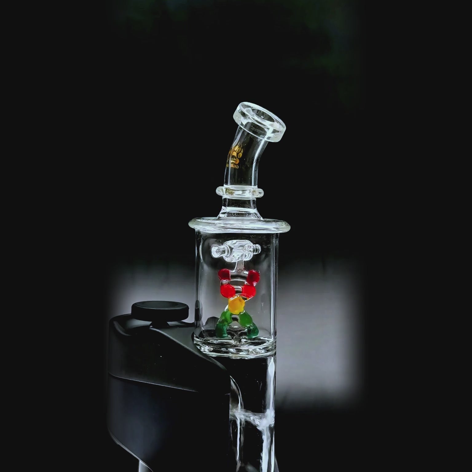 Calibear DNA Spinner Glass Attachment for Dr. Dabber Switch Go video showing the clear cylindrical glass design, colorful DNA-inspired spinner centerpiece, angled mouthpiece, and installed fit on the device (Color: Clear with Multicolor DNA Spinner)