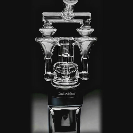 Calibear Switch²™ Duo RBR Recycler Glass Attachment for Dr. Dabber Switch 2, shown attached to a blue Switch 2 device and standalone, featuring intricate dual RBR recycler pathways and clear borosilicate glass.